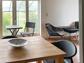 A dining area with a wooden table, two chairs, and a bowl. - 11 Person Holiday Home in Hurup Thy (Hurup Thy)