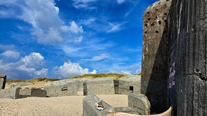 A beach with large concrete structures and a clear blue sky. - 5 Star Holiday Home in Ulfborg (Ulfborg)