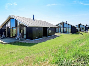A modern, single-story house with large windows and a sloped roof. - 5 Star Holiday Home in Ulfborg (Ulfborg)