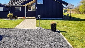 A modern house with a dark exterior, a paved driveway, and a well-maintained lawn. - 4 Star Holiday Home in Nordborg (Nordborg)