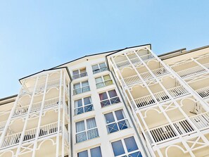 Un immeuble à plusieurs étages doté de balcons et de fenêtres.