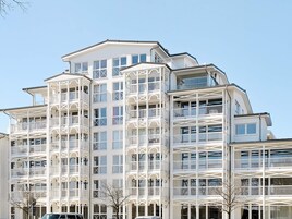 A multi-story hotel with balconies and large windows.