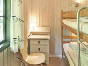 A bunk bed room with a desk and chair, a lamp, and a window with curtains. - 6 Person Holiday Home in Nexo (Nexø)