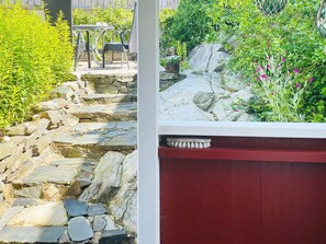A stone pathway leading to a seating area with a table and chairs. - 4 Person Holiday Home in Ronnang (Roennaeng)
