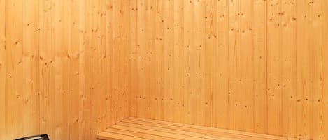 A sauna with wooden walls and benches.