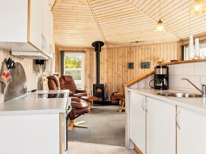 A cozy cabin interior with a kitchen, dining area, and a fireplace. - 4 Person Holiday Home in Vinderup (Vinderup)