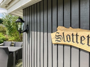 A wooden sign with the word 'Slottet' on a building exterior. - 4 Person Holiday Home in Vinderup (Vinderup)