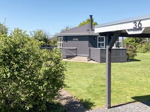 A building with a grey exterior, a chimney, and a sign indicating the number 36. - 4 Person Holiday Home in Vinderup (Vinderup)