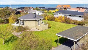 A residential area with houses, a small gazebo, and a view of the sea. - 4 Person Holiday Home in Vinderup (Vinderup)
