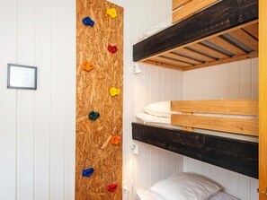 A bunk bed room with a climbing wall.