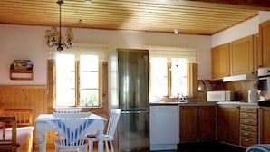 A kitchen with wooden cabinets, a stainless steel refrigerator, a microwave, and a dishwasher. - 5 Person Holiday Home in Nordingra-by Traum (Nordingra)
