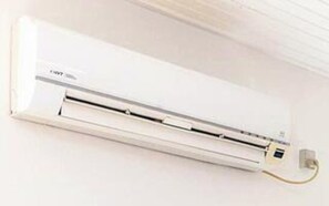 A white wall-mounted air conditioning unit with a control panel and a power cord. - 5 Star Holiday Home in Albaek (Aalbaek)
