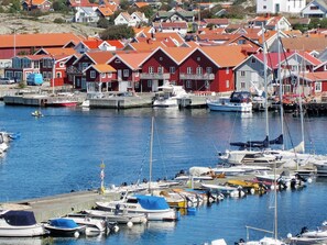 A harbor with boats docked and houses in the background. - 4 Person Holiday Home in Skarhamn (Skaerhamn)