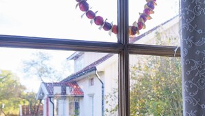 A window with a view of a house and garden.