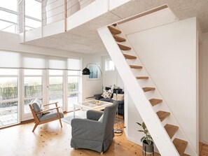 A spacious living area with a modern staircase, large windows, and a comfortable seating arrangement. - 6 Person Holiday Home in Brenderup Fyn-by Traum (Middelfart)