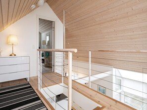 A modern interior with a wooden ceiling, a staircase, and a view of the outside. - 6 Person Holiday Home in Brenderup Fyn-by Traum (Middelfart)