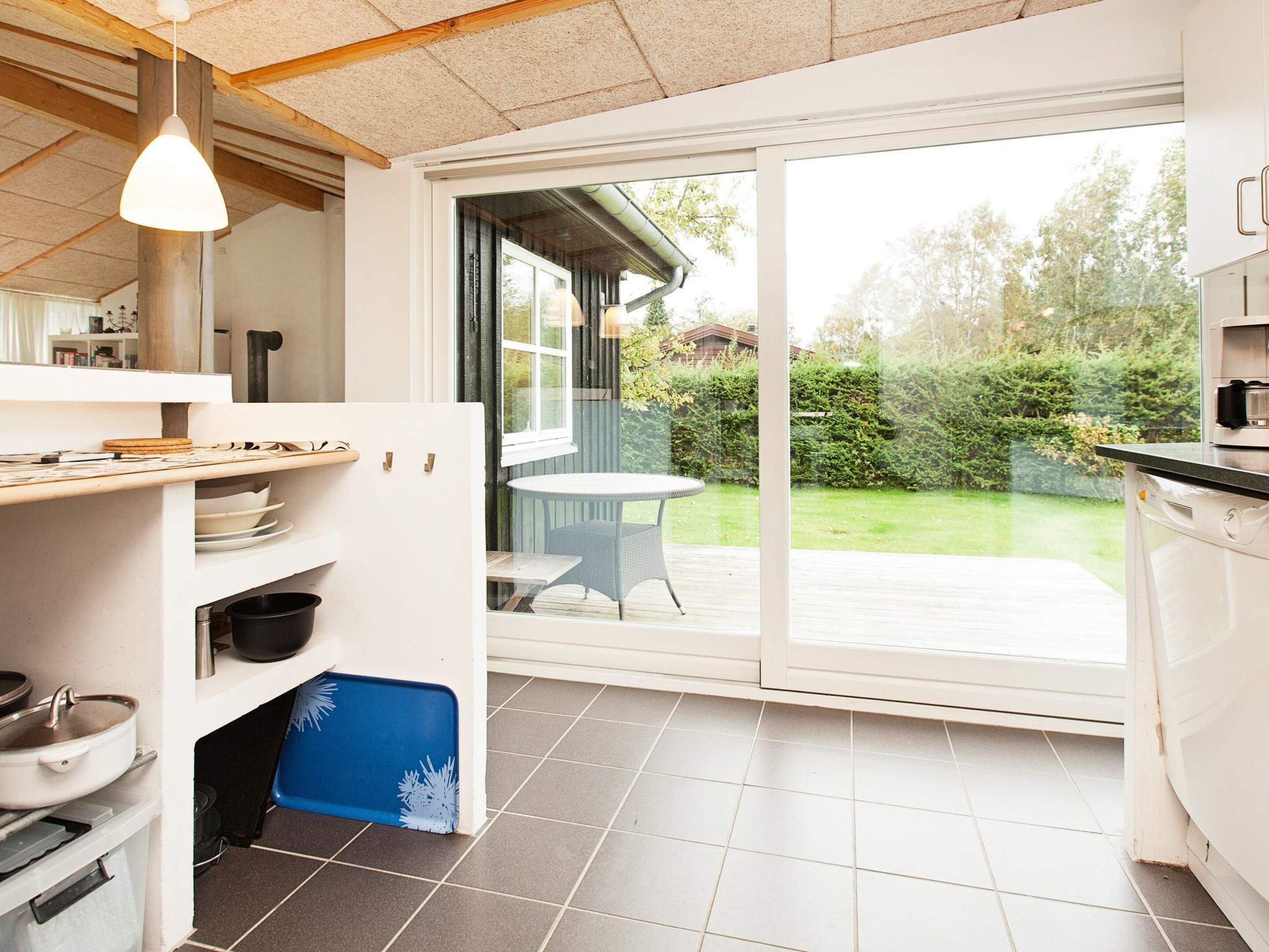 A kitchen with a large sliding glass door leading to a patio.