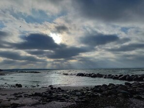 A rocky shoreline with a cloudy sky. - 5 Star Holiday Home in Bogense (Bogense)