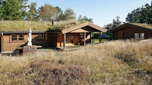 A rustic cabin with a sloped roof, wooden exterior, and a small porch area. - 5 Person Holiday Home in Strandby-by Traum (Strandby)
