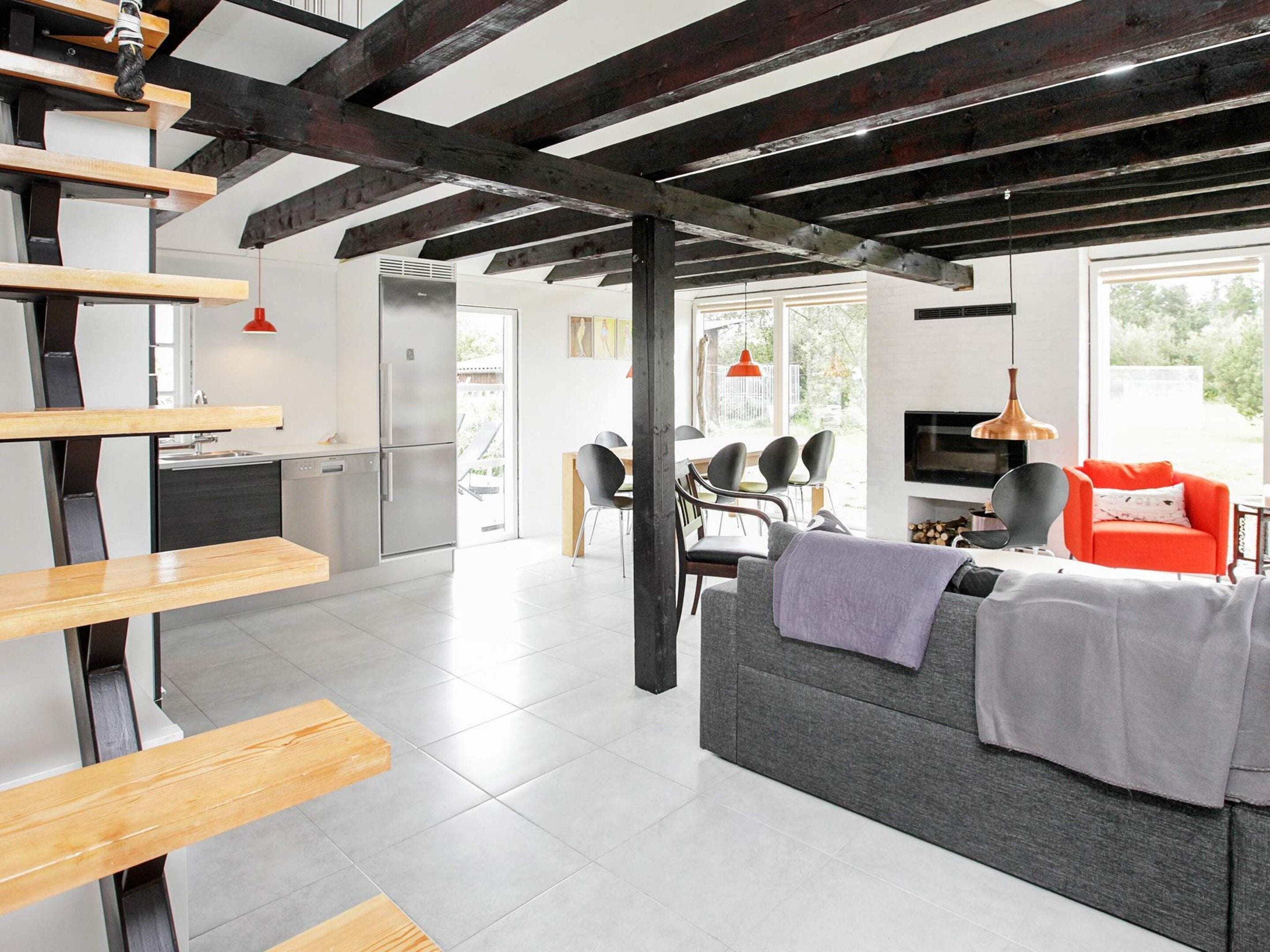 A modern interior with a kitchen, dining area, and living room.