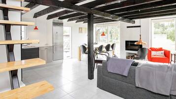 A modern interior with a kitchen, dining area, and living room.