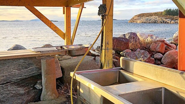 A metal sink and a hose connected to a structure by a metal pipe. - 4 Star Holiday Home in Aukra (Aukra)