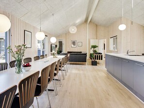 A modern kitchen with grey cabinets, a white countertop, and a hanging light fixture. - 5 Star Holiday Home in Frederiksvaerk (Frederiksvaerk)