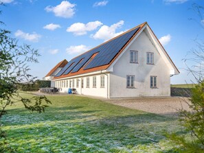 A house with a sloped roof, solar panels, and a well-maintained lawn. - 20 Person Holiday Home in Nordborg-by Traum (Nordborg)