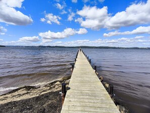 A wooden pier extending into a body of water with a clear sky above. - 6 Person Holiday Home in Borkop (Borkop)