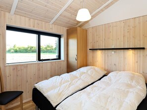 A room with a bed, a window, and a desk.