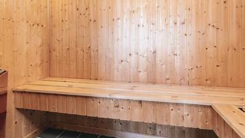 A wooden bench in a room with a tiled floor.