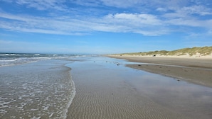 A beach with sand dunes and waves. - 5 Star Holiday Home in Lokken (Lokken)