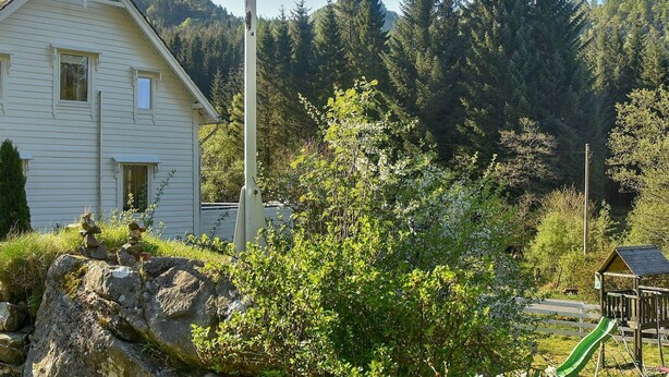 A house with a sloped roof, a chimney, and a window. - 8 Person Holiday Home in Uggdal (Tysnes)