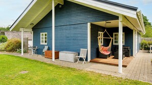 A house with a covered porch, a hammock, outdoor furniture, and a small shed. - 9 Person Holiday Home in Jaegerspris-by Traum (Jægerspris)