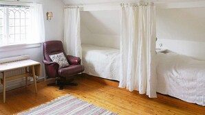 A bedroom with a single bed, a chair, a desk, and a window with curtains. - 6 Person Holiday Home in Arjang (Årjäng)