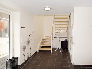 A modern interior with a staircase, a coat rack, and a washing machine. - 4 Star Holiday Home in Hemmet (Hemmet)