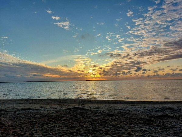 A beach with a sunset over the water. - 4 Star Holiday Home in Hemmet (Hemmet)