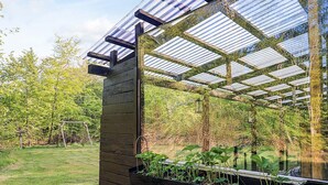 A greenhouse structure with a wooden exterior and a transparent roof. - 6 Person Holiday Home in Hadsund-by Traum (Hadsund)