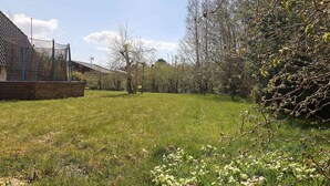 A grassy yard with a wooden deck and a house in the background. - 6 Person Holiday Home in Hurup Thy-by Traum (Hurup Thy)