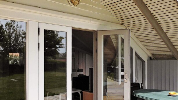 A covered patio with a sliding glass door leading to an outdoor area. - 4 Star Holiday Home in Sydals (Sydals)