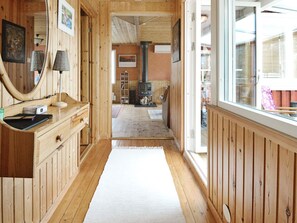A wooden interior with a fireplace, a mirror, and a window. - 7 Person Holiday Home in Allingsas, Sverige (Alingsas)