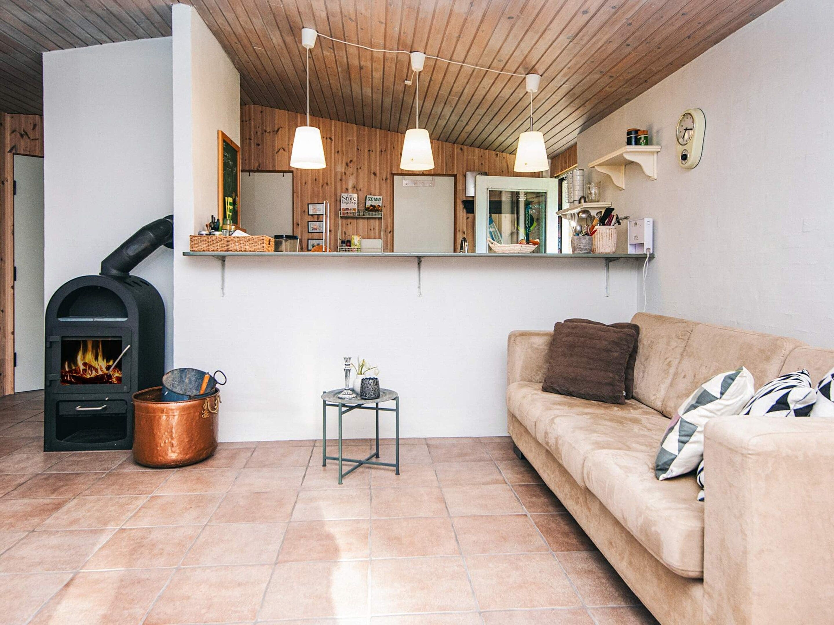 A cozy living room with a fireplace, a sofa, and a coffee table.