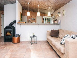 A cozy living room with a fireplace, a sofa, and a coffee table.