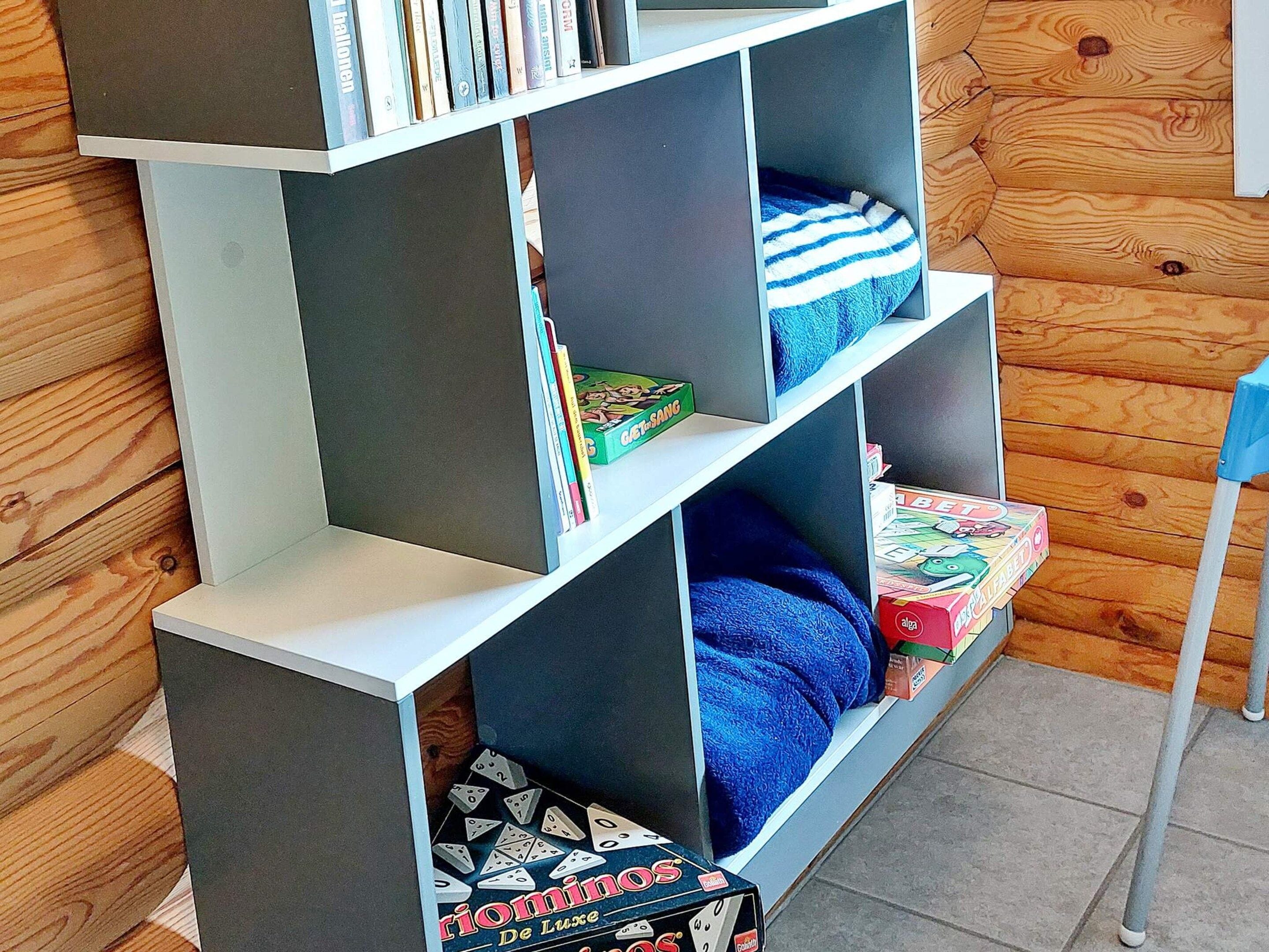 A bookshelf with various books and board games.