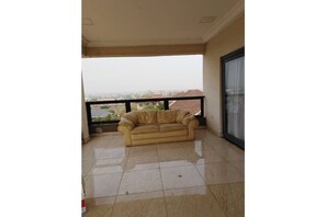 Relax on the balcony with a comfortable sofa and take in the urban views.