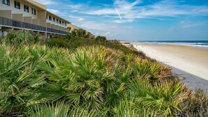 A beachfront hotel with a long building, a sandy beach, and ocean views. - Tier 1. Oceanfront 2 bedroom, 2.5 bath townhouse. (St. Augustine)