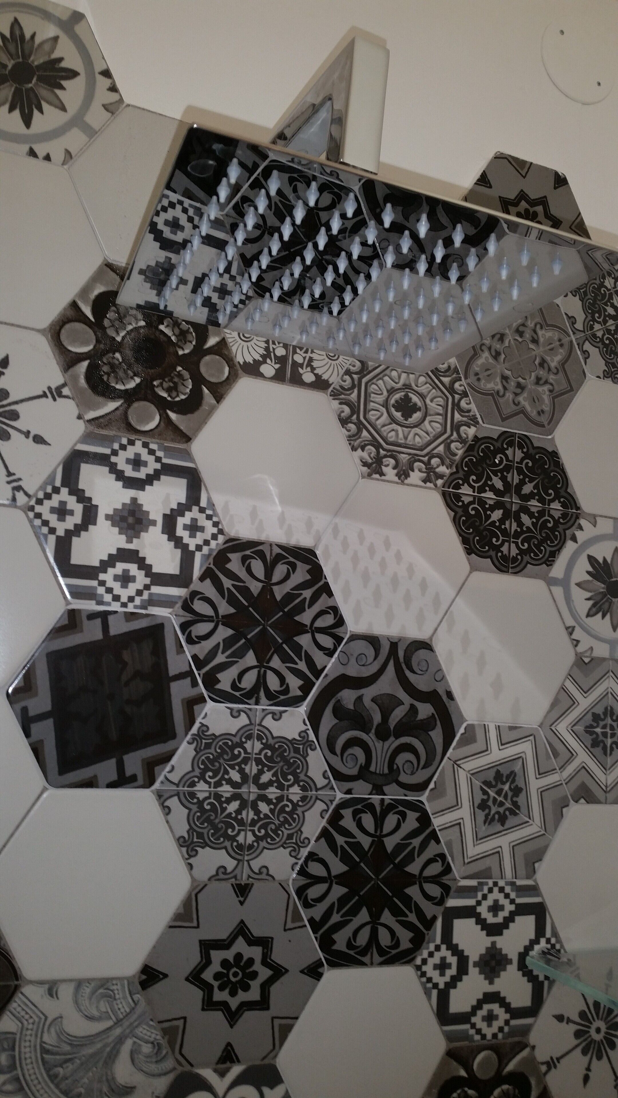 A floor with a variety of hexagonal tiles featuring different patterns and designs.