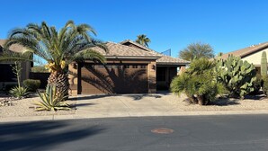 A residential house with a garage, palm trees, and cacti in the driveway. - Golfer's Paradise!!!-On Johnson Ranch Golf Course with pool! (San Tan Valley)