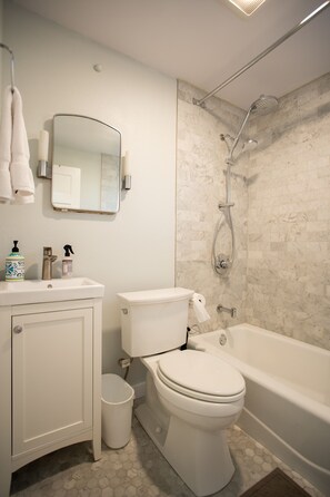 Combined shower/bathtub, towels, soap, toilet paper