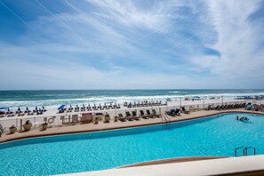 Relax by the ocean with views of the sea from our pool area, surrounded by sun loungers and umbrellas.